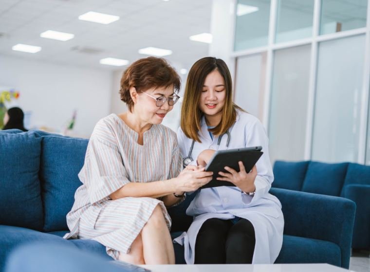 Support worker and client reviewing information on a tablet