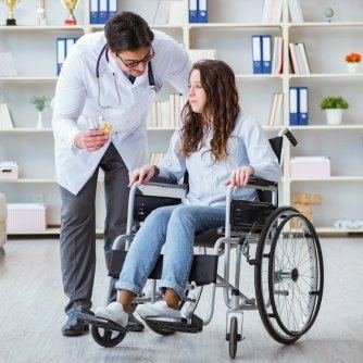 Doctor talking with a woman in a wheelchair